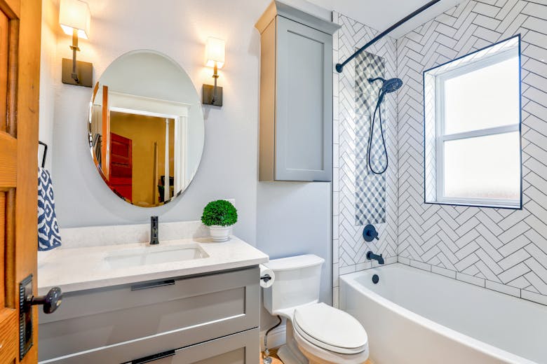 Renovated bathroom with herringbone tile and modern vanity