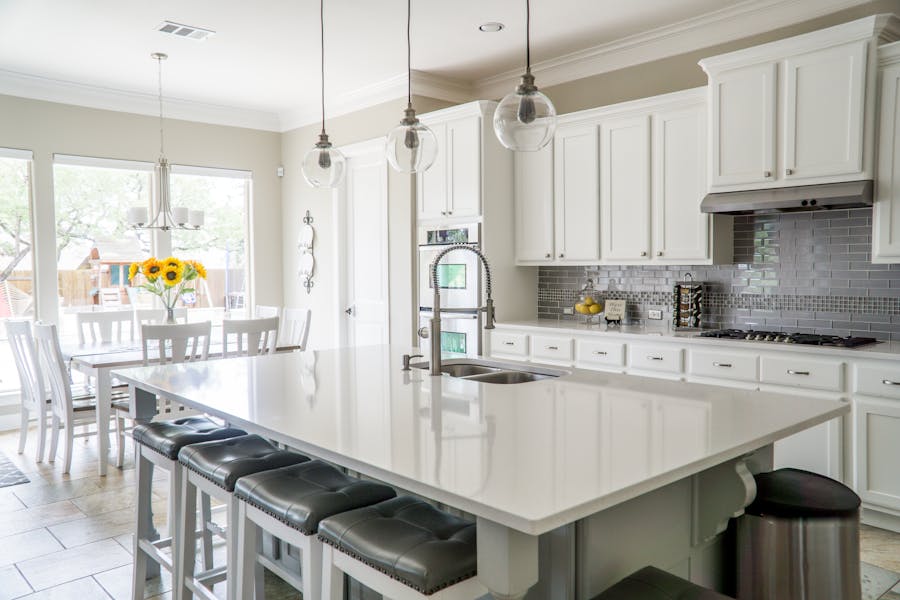 Bright open-plan kitchen remodel with large island and pendant lighting